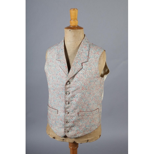 292 - A mid19th century waistcoat for a young gentleman, woven with red and turquoise on a cream ground, t... 