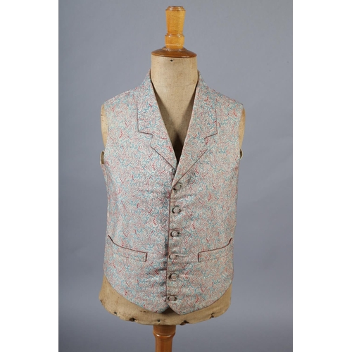 292 - A mid19th century waistcoat for a young gentleman, woven with red and turquoise on a cream ground, t... 