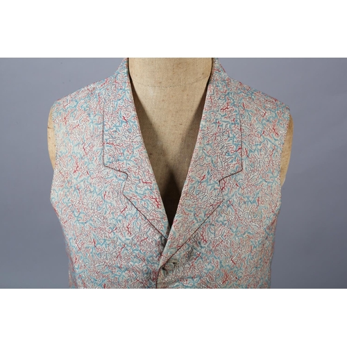 292 - A mid19th century waistcoat for a young gentleman, woven with red and turquoise on a cream ground, t... 