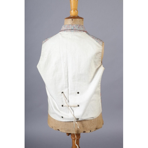 292 - A mid19th century waistcoat for a young gentleman, woven with red and turquoise on a cream ground, t... 