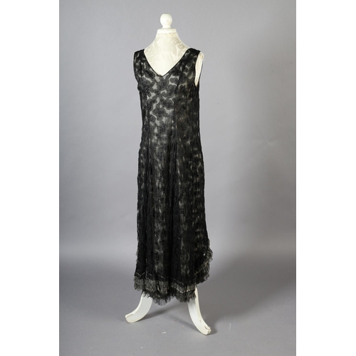 296 - A black lace 1920’s dress, full length, sleeveless, with cream silk lining, side fastening with hook... 