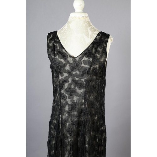 296 - A black lace 1920’s dress, full length, sleeveless, with cream silk lining, side fastening with hook... 