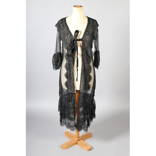 297 - An early 20th century black net evening coat, mid-calf to full length, elbow-length sleeves finished... 