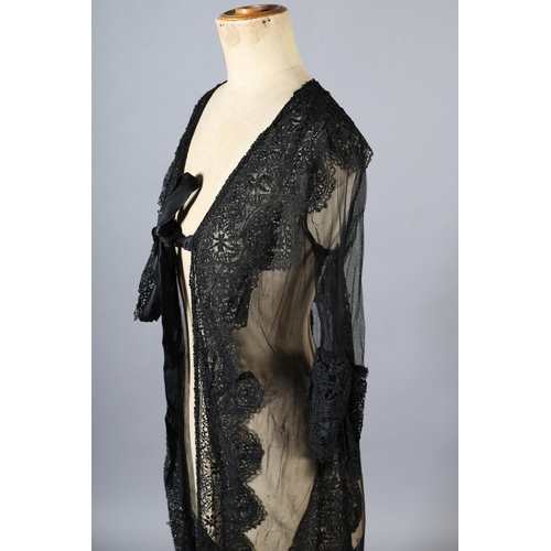 297 - An early 20th century black net evening coat, mid-calf to full length, elbow-length sleeves finished... 