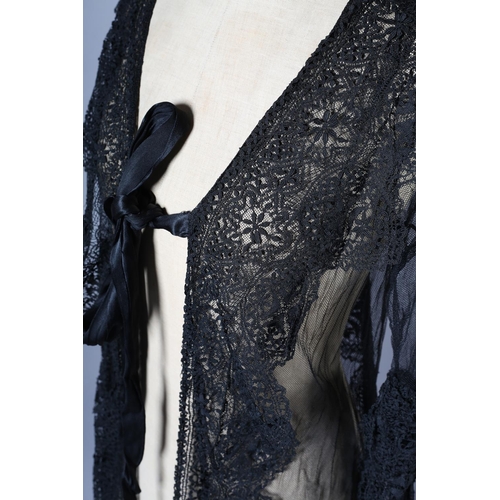 297 - An early 20th century black net evening coat, mid-calf to full length, elbow-length sleeves finished... 