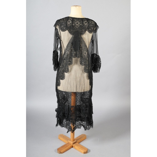 297 - An early 20th century black net evening coat, mid-calf to full length, elbow-length sleeves finished... 