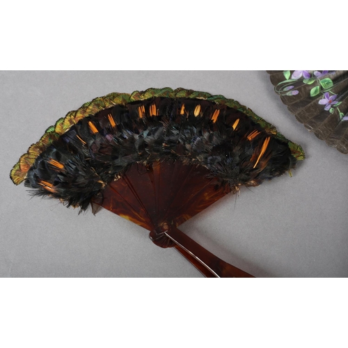 31 - A 19th century glazed cotton cockade fan, painted with violets, the leaf contained in a strong cardb... 