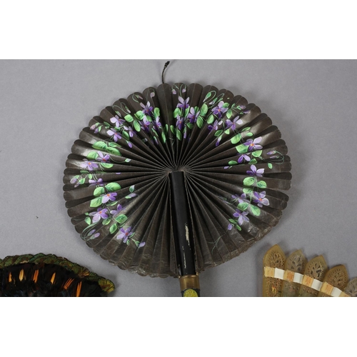 31 - A 19th century glazed cotton cockade fan, painted with violets, the leaf contained in a strong cardb... 