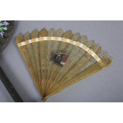 31 - A 19th century glazed cotton cockade fan, painted with violets, the leaf contained in a strong cardb... 