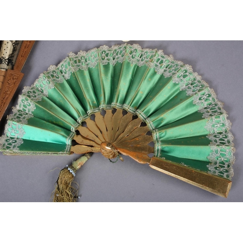 33 - A c.1880’s wood fan, the monture with deeply carved guards, the gorge sticks with simple piercing, m... 