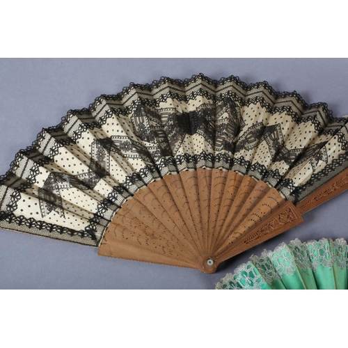 33 - A c.1880’s wood fan, the monture with deeply carved guards, the gorge sticks with simple piercing, m... 