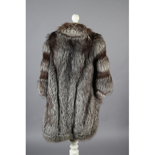 367 - Silver fox: a three- quarter length silver fox jacket in cape form, the front and back dipping in th... 