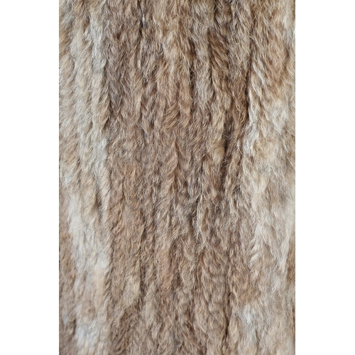 368 - A stylish tan fur jacket, hip length, labelled Gil Bret, the collar, front and long sleeves trimmed ... 