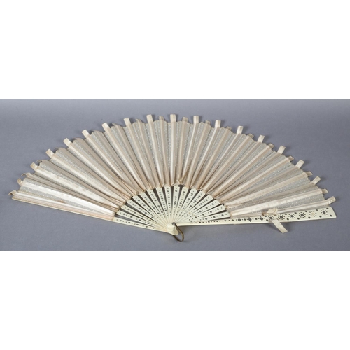 37 - A large late 1890’s fan with unusual cream silk ribbon work detail applied to spotted net, mounted à... 