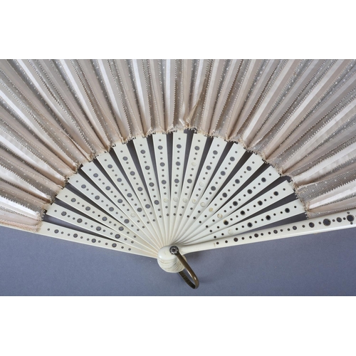 37 - A large late 1890’s fan with unusual cream silk ribbon work detail applied to spotted net, mounted à... 