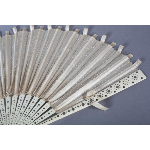 37 - A large late 1890’s fan with unusual cream silk ribbon work detail applied to spotted net, mounted à... 