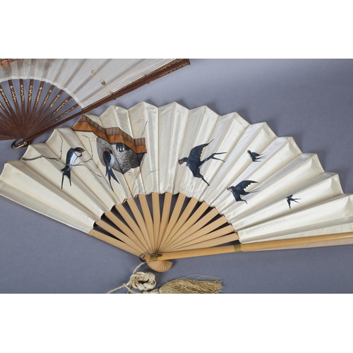 38 - A good late 1890’s wood fan, the cream silk satin leaf panted with birds returning to a nest in the ... 