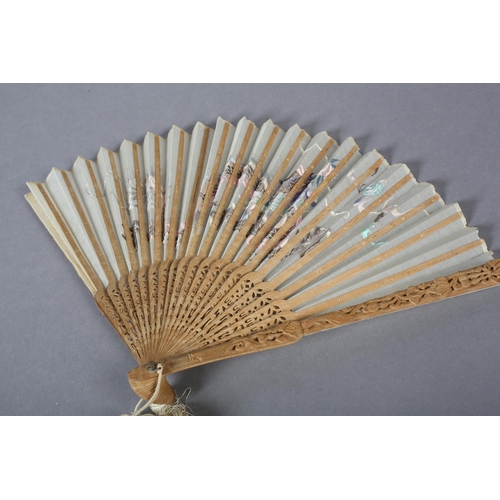 58 - A 20th century Chinese carved sandalwood fan, the white cotton gauze leaf embroidered in pastel silk... 