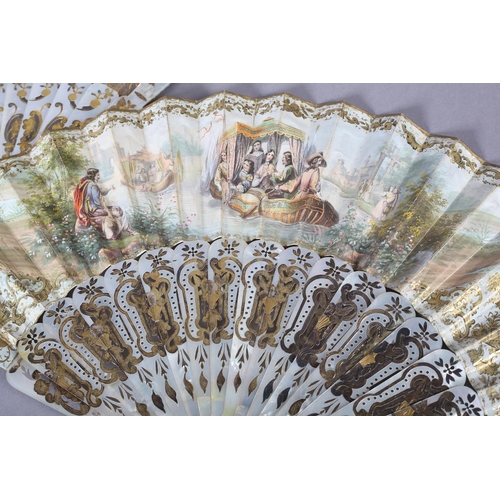 68 - Two white mother of pearl mid-19th century fans, elaborately gilded and silvered, the leaves lithogr... 