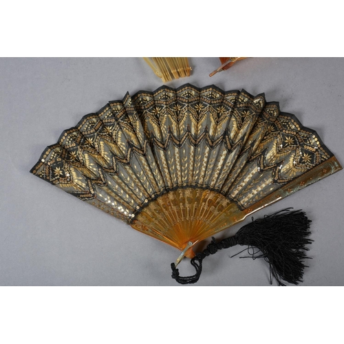 72 - c.1900, three horn fans, the first mounted with gold lamé fabric and extravagantly  embroidered with... 