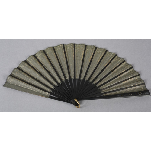 74 - A good and fairly large sequined fan, c 1900, the gold lamé leaf overlaid on alternate folds with bl... 