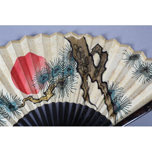 92C - An unusual, large, Chinese fan, Qing Dynasty, the monture wood, with black lacquer, the guards featu... 