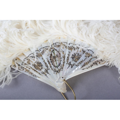 96 - A good late 19th century white ostrich feather fan, the monture of slightly pink white mother of pea... 