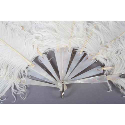 97 - A late 19th century white ostrich feather fan, the monture of white mother of pearl, plain other tha... 