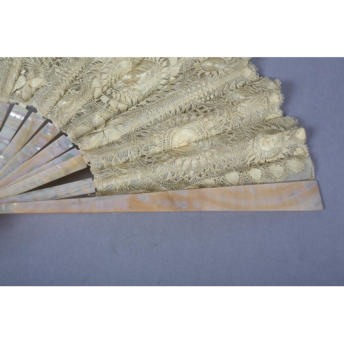 145 - Tenerife or Sol handmade lace: a pink mother of pearl fan mounted with a lemon silk leaf formed with... 