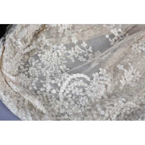 210 - Antique lace: A triangular shawl in embroidered net, with deeper detail to the back point (neck to p... 