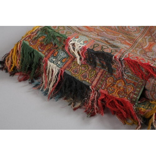 253 - A very fine Paisley or French Long Shawl, with a very tight weave, a red cross to the centre, intric... 