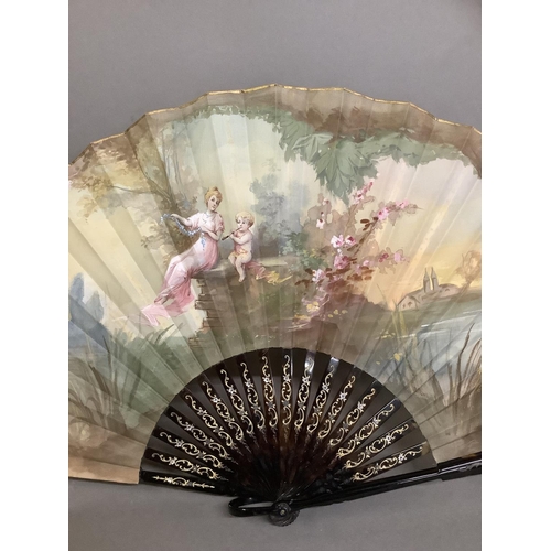 11 - c.1900/1910, an attractive tortoiseshell fan, the monture gilded, mounted with a silk leaf, painted ... 