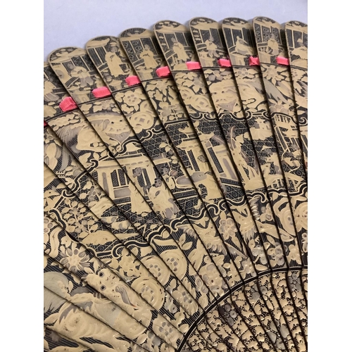 133 - A very good, c.1830’s Chinese black and gold lacquered brisé fan, the gold particularly heavily appl... 