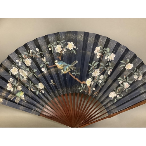 135C - A large selection of Chinese tourist fans, from the 20th century, one very large with birds and blos... 