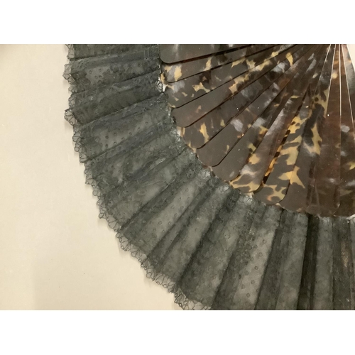 142 - A tortoiseshell fan, c 1880’s with good mottling, mounted with a black handmade lace leaf, the desig... 