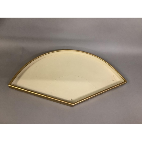 171 - A shaped and glazed fan frame, the wood exterior gilded, backed with green moiré patterned paper, fi... 