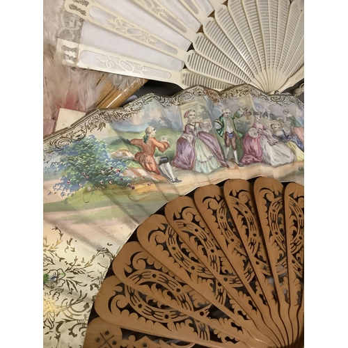 22 - Four fans, mid-19th century onwards, to include a pierced wood example, the lithographed leaf featur... 