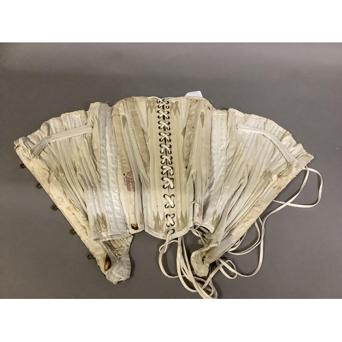 262 - A cream 19th century cotton corset, boned and back laced, bearing a woven label for “Mon J. Lefranc,... 