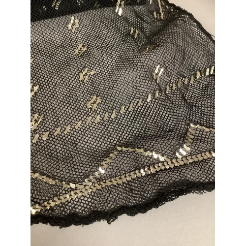 278 - A 1920’s azute or assuit shawl, black net with silver metal geometric design, approx. 255cm x 5cm