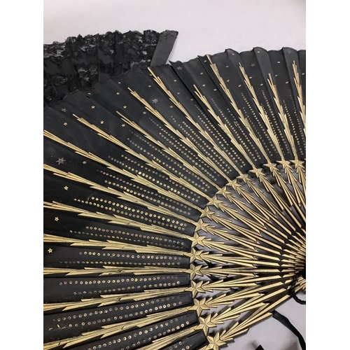 64 - Two 1890’s fans, black, the first fashioned à la Sultane, the head shaped, the design that of a star... 