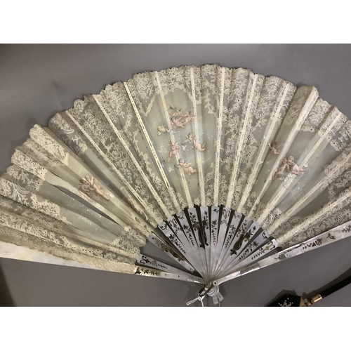 70 - Fans: one late 19th century with gilded mother of pearl monture and painted gauze leaf; a smaller c ... 