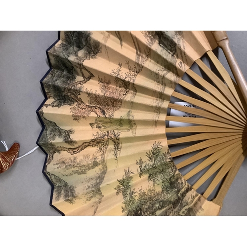 92D - A collection of 20th century Chinese fans, to include two examples with cream gauze leaves, embroide... 