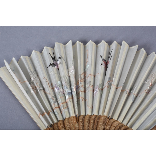 135D - A 20th century Chinese carved sandalwood fan, the white cotton gauze embroidered with two colourful ... 