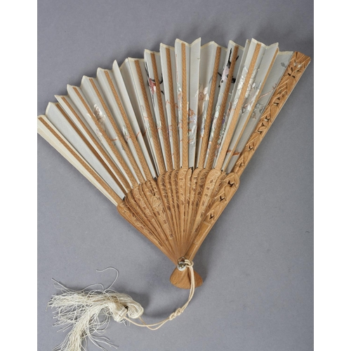 135D - A 20th century Chinese carved sandalwood fan, the white cotton gauze embroidered with two colourful ... 