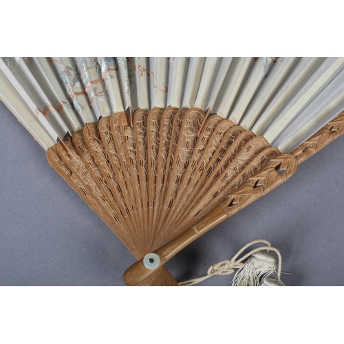 135D - A 20th century Chinese carved sandalwood fan, the white cotton gauze embroidered with two colourful ... 