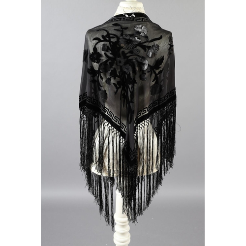 355 - Two 20th century black cut velvet garments, one a draped top, hip-length, the other a fringed shawl,... 