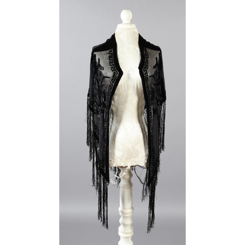 355 - Two 20th century black cut velvet garments, one a draped top, hip-length, the other a fringed shawl,... 