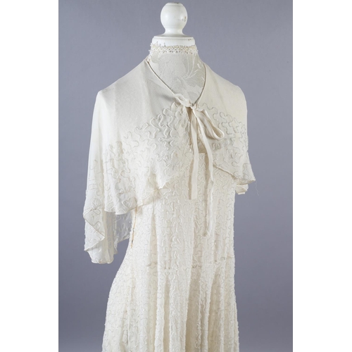 360 - A cream 1920’s chiffon wedding dress and shoulder cape, decorated with clear beads, the dress sleeve... 