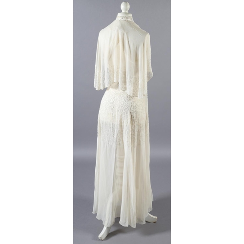 360 - A cream 1920’s chiffon wedding dress and shoulder cape, decorated with clear beads, the dress sleeve... 