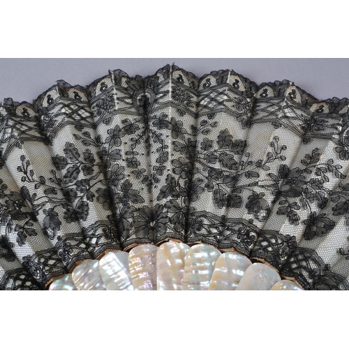 76 - c.1880’s a pink mother of pearl fan mounted with cream satin and overlaid with black handmade lace w... 